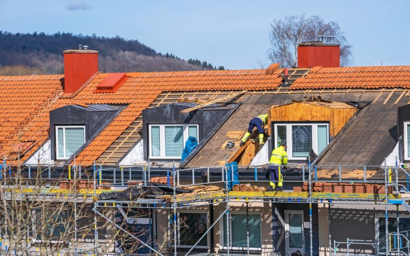 Falköping, Sweden - April 08, 2021: Carpenter working on a roof